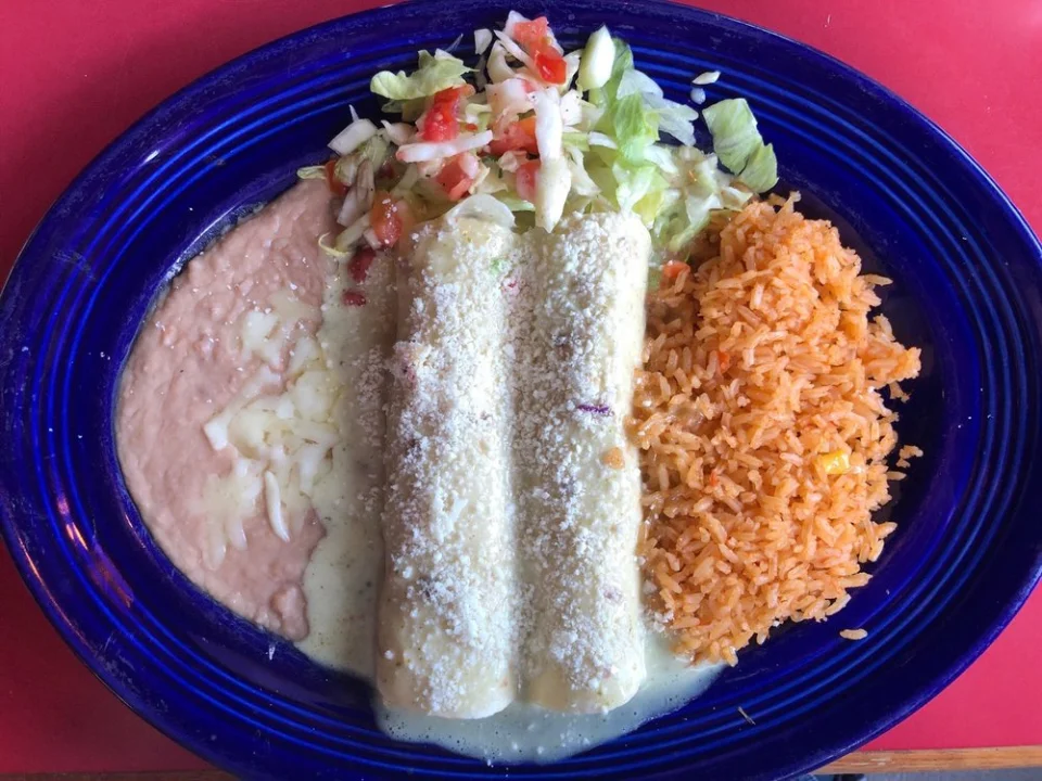 Enchiladas Borrachas - Corn tortillas filled with your choice of protein, smothered in our signature borrachas sauce and topped with melted cheese.